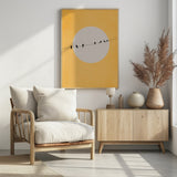 birds on wire poster with yellow background, wood furniture room